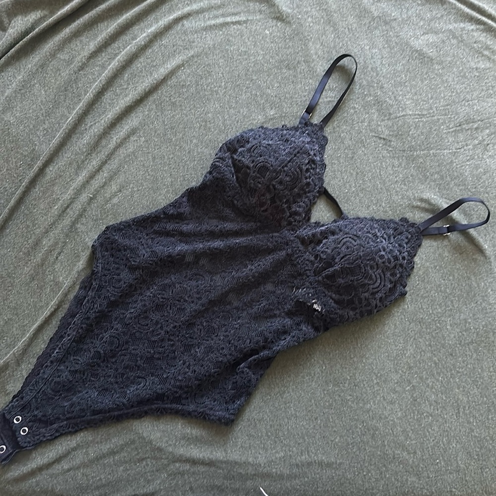 Black velvet bodysuit with open back.